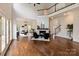 Spacious living room featuring a stone fireplace, hardwood floors, and ample natural light at 11841 Churchfield Ln, Charlotte, NC 28277