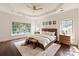 Serene main bedroom with tray ceilings, hardwood floors, and many windows at 11841 Churchfield Ln, Charlotte, NC 28277