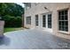Rear view of a brick home with a blue stone patio at 11841 Churchfield Ln, Charlotte, NC 28277