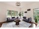 Cozy sitting room with two sofas, a decorative rug, and natural light from large windows at 11841 Churchfield Ln, Charlotte, NC 28277