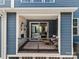 Cozy balcony with stone fireplace, comfortable seating, and neutral decor at 120 August Ln, Stallings, NC 28104