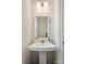 Bathroom featuring a modern, rectangular, white sink, decorative mirror, and contemporary lighting at 120 August Ln, Stallings, NC 28104