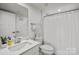 Bright bathroom featuring a white vanity, large mirror, and shower with a white curtain at 120 August Ln, Stallings, NC 28104
