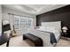 Modern bedroom with a black accent wall, light colored walls, and bright natural light at 120 August Ln, Stallings, NC 28104