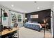 Modern bedroom with sleek black accent wall, large window, and comfortable furnishings at 120 August Ln, Stallings, NC 28104