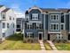 Inviting blue townhome with brick accents and a well-manicured lawn at 120 August Ln, Stallings, NC 28104