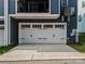 Spacious two-car garage with white doors and ample driveway parking at 120 August Ln, Stallings, NC 28104