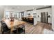 Stylish kitchen featuring stainless steel appliances, a center island with seating, and an adjacent dining area at 120 August Ln, Stallings, NC 28104