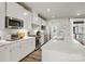 Modern kitchen with white cabinets, stainless steel appliances, and a spacious countertop at 120 August Ln, Stallings, NC 28104