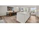 Bright kitchen featuring a white island, a wooden dining table, and a comfortable living area at 120 August Ln, Stallings, NC 28104