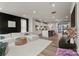 Open-concept living room with a comfortable sofa, a modern kitchen, and a sliding glass door to the patio at 120 August Ln, Stallings, NC 28104