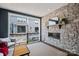 Relaxing covered patio showcasing a stone accent wall with a fireplace and neighborhood view at 120 August Ln, Stallings, NC 28104