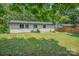 Rear view of home showing a well maintained vinyl exterior and a spacious lawn with green grass at 1214 Northwoods Dr, Kings Mountain, NC 28086