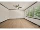 Bright bedroom with hardwood floors, ceiling fan, and a large window overlooking the trees at 1214 Northwoods Dr, Kings Mountain, NC 28086