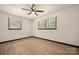 Bright and airy bedroom with laminate flooring, a ceiling fan, and natural light through the windows at 1214 Northwoods Dr, Kings Mountain, NC 28086