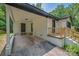 View of the house carport showing two doors, brick foundation, and wood stairs at 1214 Northwoods Dr, Kings Mountain, NC 28086