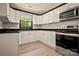 Modern kitchen features stainless steel appliances, granite countertops, and white cabinets at 1214 Northwoods Dr, Kings Mountain, NC 28086