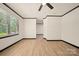 Bright living room boasts wood floors, a ceiling fan, and a large window at 1214 Northwoods Dr, Kings Mountain, NC 28086