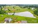 An aerial view of the property featuring a pond in the background and green fields at 124 Vintage Woods Ct, Shelby, NC 28150