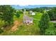 Expansive aerial view of a home with a lovely backyard, featuring a charming pergola and garden plots at 124 Vintage Woods Ct, Shelby, NC 28150