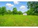 Large backyard with outbuilding, lawn, and beautiful mature trees at 124 Vintage Woods Ct, Shelby, NC 28150