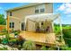 A backyard deck has a canopy, plants, and a view of the yard and the home's siding at 124 Vintage Woods Ct, Shelby, NC 28150