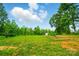 Expansive backyard with a beautiful garden bed on a verdant lawn area at 124 Vintage Woods Ct, Shelby, NC 28150