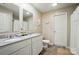 Bright bathroom with double vanity, granite countertops, and wood-look floors at 124 Vintage Woods Ct, Shelby, NC 28150