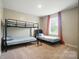 This bedroom features carpet, window with drapes, and bunk beds with a ladder at 124 Vintage Woods Ct, Shelby, NC 28150