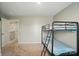 A bedroom features carpeting, bunk beds with a ladder, and door to the hallway at 124 Vintage Woods Ct, Shelby, NC 28150