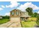 Inviting brick home featuring green shutters, a cozy front porch, and a two-car garage at 124 Vintage Woods Ct, Shelby, NC 28150
