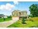Charming two-story brick home with a spacious driveway and manicured lawn with ornamental landscaping at 124 Vintage Woods Ct, Shelby, NC 28150