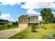 Charming two-story brick home with green shutters, a well-manicured front yard and a two-car garage at 124 Vintage Woods Ct, Shelby, NC 28150