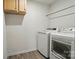 The laundry room features modern, white washer and dryer units and vinyl flooring at 124 Vintage Woods Ct, Shelby, NC 28150