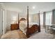 Spacious main bedroom with a four-poster bed, complemented by side tables and lamps at 124 Vintage Woods Ct, Shelby, NC 28150