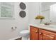 Bathroom with a cherry vanity cabinet, decorative mirror and overhead lighting at 14904 Rosemary Way Dr, Huntersville, NC 28078