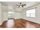 This bedroom is spacious with hardwood flooring, large windows, and a ceiling fan at 14904 Rosemary Way Dr, Huntersville, NC 28078
