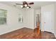 Bright bedroom featuring hardwood floors, ceiling fan and natural light from the double window at 14904 Rosemary Way Dr, Huntersville, NC 28078