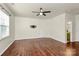 This bedroom includes hardwood flooring, a ceiling fan, and a window with natural light at 14904 Rosemary Way Dr, Huntersville, NC 28078