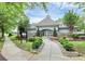 Beautiful entrance to community clubhouse with manicured landscaping and stone accents at 14904 Rosemary Way Dr, Huntersville, NC 28078