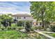 Charming two-story home with landscaped yard, garden beds, and inviting entrance at 14904 Rosemary Way Dr, Huntersville, NC 28078