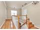 Upstairs hallway with hardwood floors, neutral walls, white trim, and natural light filtering through a window at 14904 Rosemary Way Dr, Huntersville, NC 28078