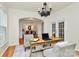 Bright home office with a large desk and stylish decor at 14904 Rosemary Way Dr, Huntersville, NC 28078
