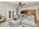 Spacious living room with large sectional sofa, ceiling fan, and an archway view to the kitchen at 14904 Rosemary Way Dr, Huntersville, NC 28078
