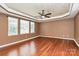 Bright main bedroom featuring hardwood floors, neutral walls, tray ceilings, and large windows with natural light at 14904 Rosemary Way Dr, Huntersville, NC 28078
