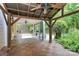 Outdoor living space featuring a covered patio, wooden tile area, and beautiful landscaping at 14904 Rosemary Way Dr, Huntersville, NC 28078