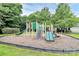 The community playground is surrounded by green trees, and it has multiple slides at 14904 Rosemary Way Dr, Huntersville, NC 28078