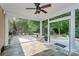 Screened porch with tiled floor and access to the backyard with a concrete patio and landscaping at 14904 Rosemary Way Dr, Huntersville, NC 28078