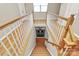 Bright and airy staircase with wood treads, white risers, and natural wood and white banister leading to lower level at 14904 Rosemary Way Dr, Huntersville, NC 28078