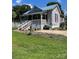 Charming home with a light blue metal roof, vinyl siding and a welcoming front porch at 15 Rose St, York, SC 29745